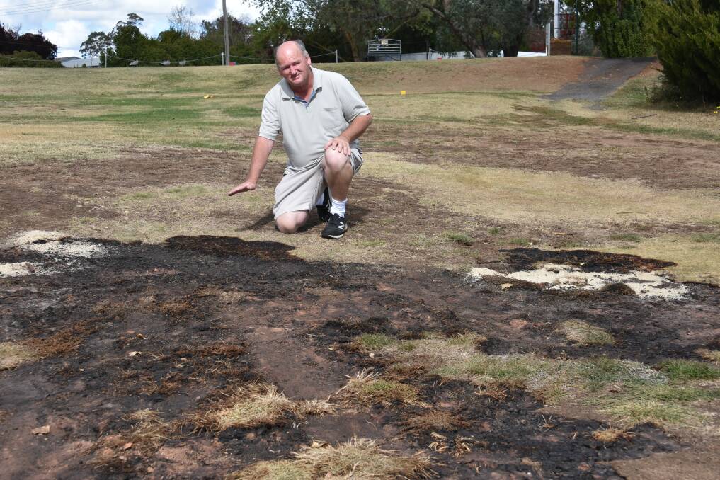Charred greens: Guyra Bowling and Recreation Club vice-president David Wilcox on the course where the underground fire continues to burn.