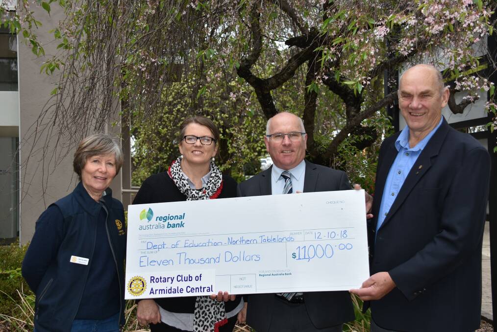 CHEQUE FOR KIDS: Rotary members Greta Williamson, Meg Georkas, and Alan Francis (right) presenting an $11,000 cheque to the Department of Education's Pat Cavanagh (second from right). Photo: Nicholas Fuller