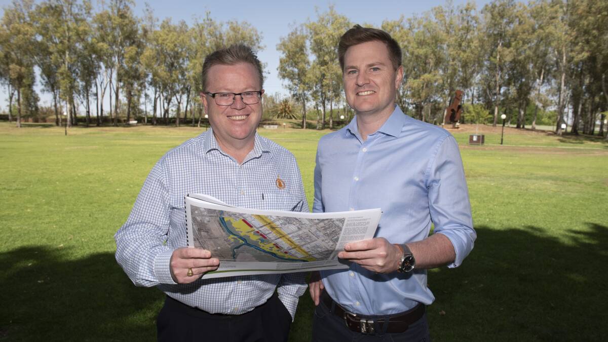 COMPREHENSIVE: Council general manager Paul Bennett and sports and recreation officer Sam Eriksson with the Bicentennial Park draft masterplan. Photo: Peter Hardin 071119PHB020