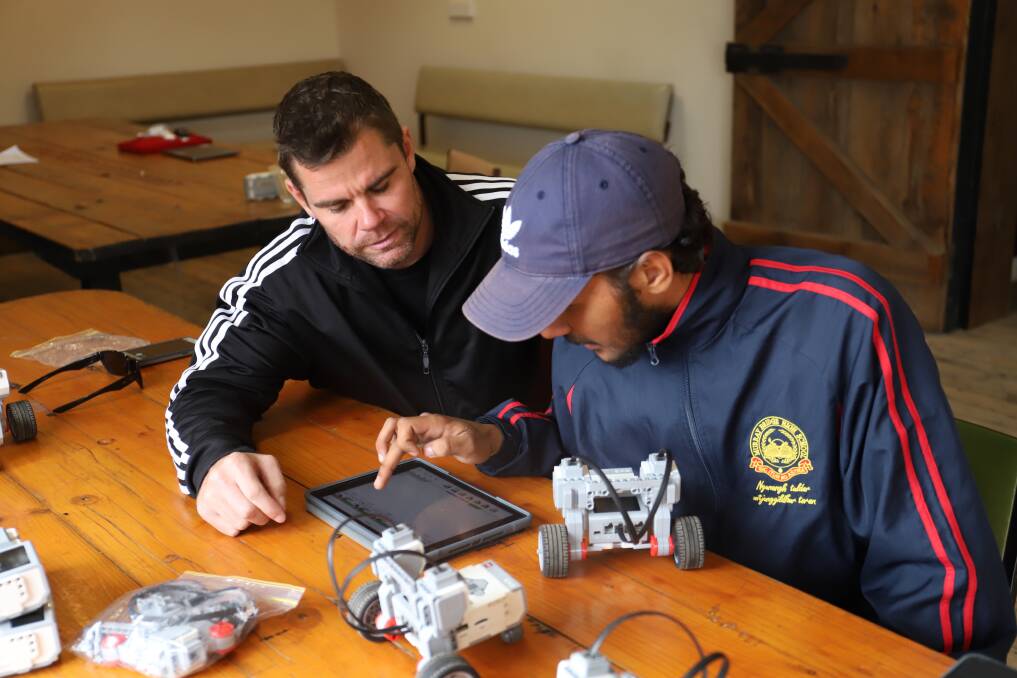 TECHNO TUTOR: IDX Flint Manager Grant Cameron showing Murray Bridge student Tyreech O'Loughlin how to program a lego robot. Photo: Supplied