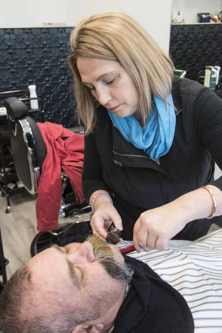 EXPERIENCE: Kylie Potts working on a beard trim at 2340 Barbershop's grand opening. Photo: Peter Hardin