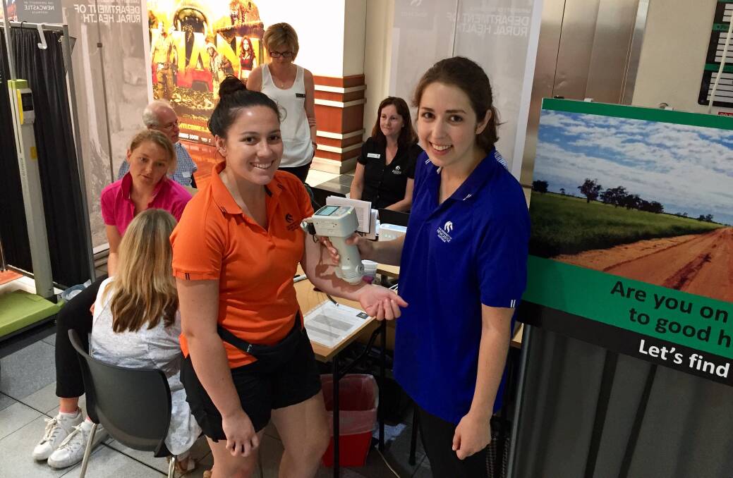 TESTING TIMES: Tamworth dietetics students Madison Beringer and Natalie Vella helped test festival-goers at the Centrepoint Mall. Photo: Jacob McArthur 240118JMA01