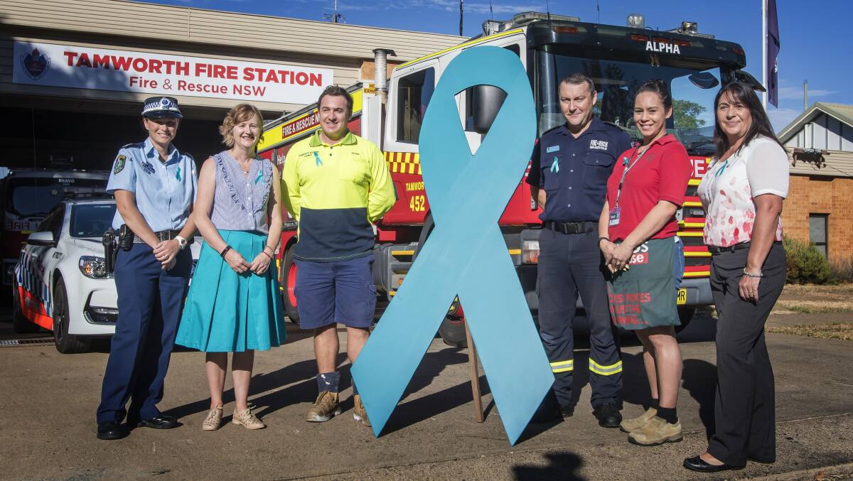 THE GANG: Oxley police, council staff, Fire and Rescue, Bunning and post office staff have donned the ribbon. Photo: Peter Hardin