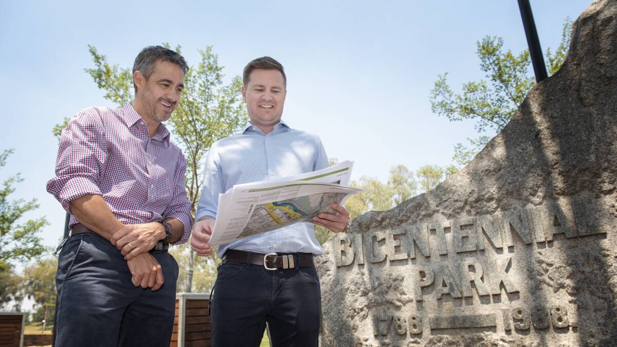 HAVE YOUR SAY: Council sports and recreation officers Paul Kelly and Sam Eriksson look over the draft park plan. Photo: Peter Hardin 281019PHA022