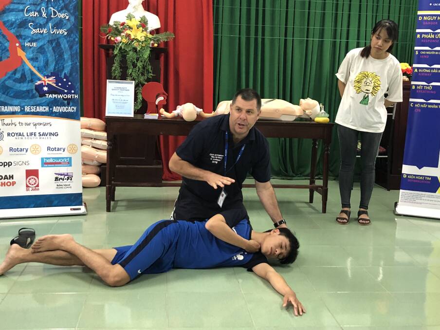 ROLLED OUT: Tamworth man Cameron McFarlane delivering his CPR class in a Vietnamese school recently. Photo: Supplied