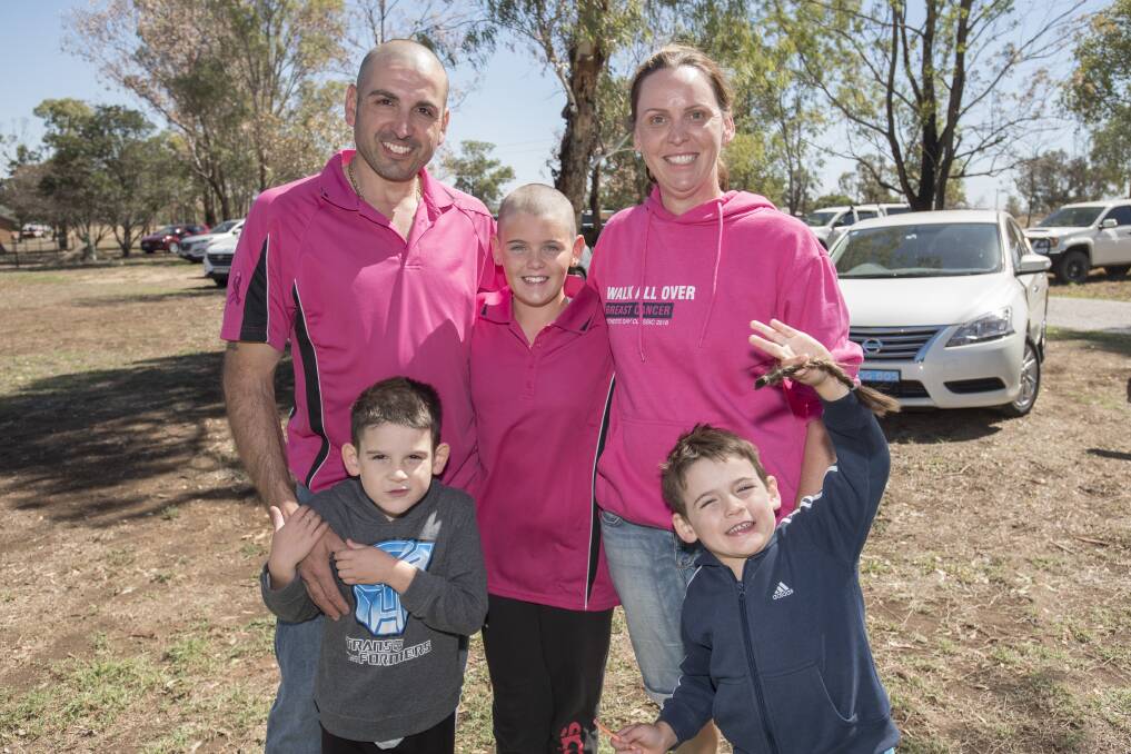 HEAD HELD HIGH: Lily Androutsos (middle) shaved her head to raise money for cancer research supported by parents George and Kristy along with brothers Theo and Andreas. Photo: Peter Hardin 310319PHC226