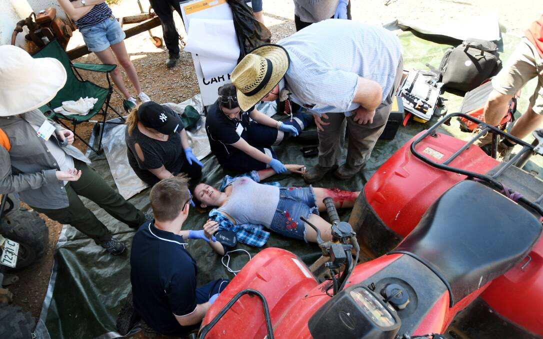 HELPING HAND: Health students tend to a mock casualty on a Tamworth farm. Photo: Gareth Gardner 031118GGB01