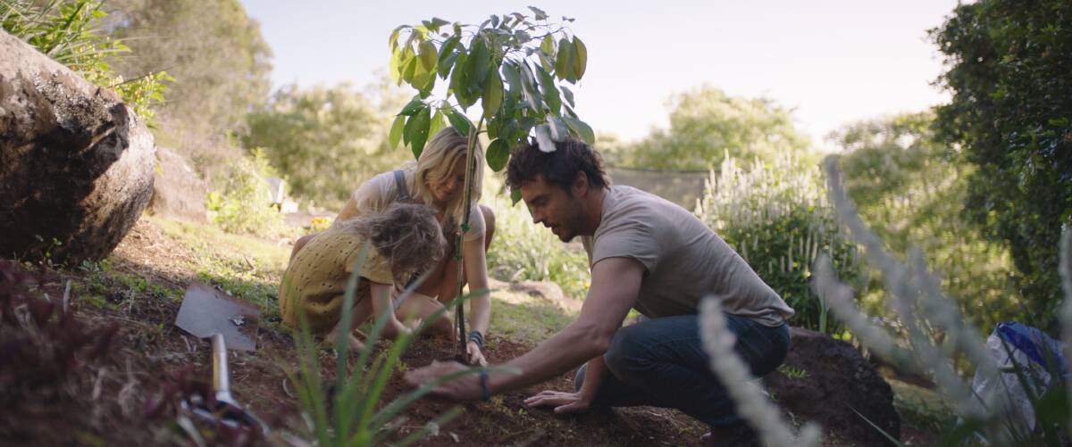 SEEDS SOWN: Damon Gameau planting a tree with his daughter and wife for his new documentary 2040. Photo: AAP
