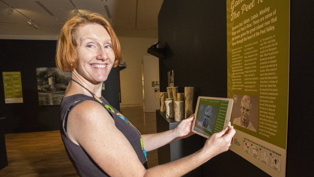 STATE OF ART: Tamworth Regional Gallery director Bridget Guthrie tries out the augmented reality aspect of a new exhibition. Photo: Peter Hardin 091216PHC056