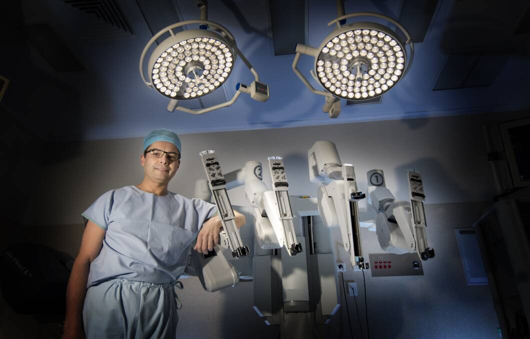 STATE OF THE ART: Tamworth urologist Ramin Samali with the city's new surgical robot, nicknamed Rupert, it's believed to be first of its kind in regional Australia. Photo: Peter Hardin 020518PHA063