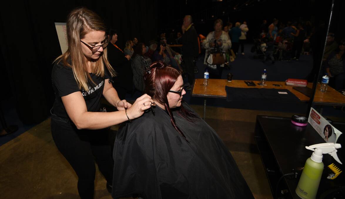 HELPING HANDS: Amber Lahrs giving one of many free haircuts at Homeless Connect Day. Photo: Gareth Gardner