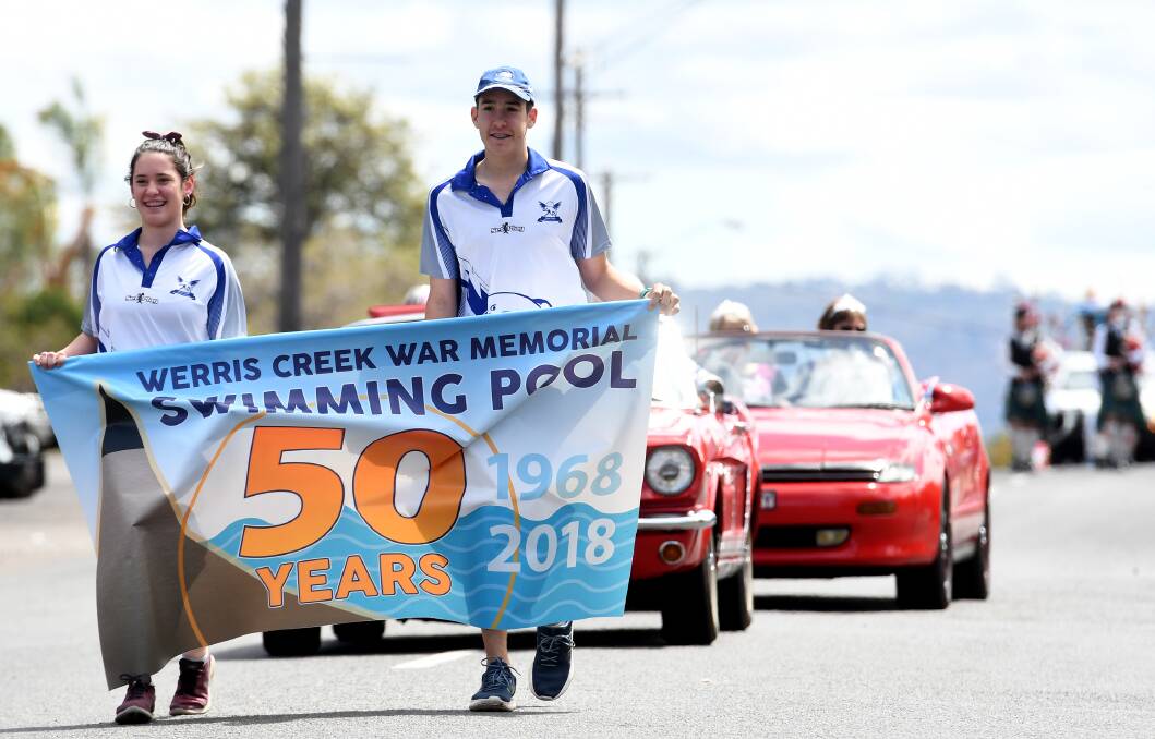 LAPPING IT UP: Annabelle Avard and Liam Faulkner lead the parade down the town's main drag. Photo: Gareth Gardner 061018GGA12