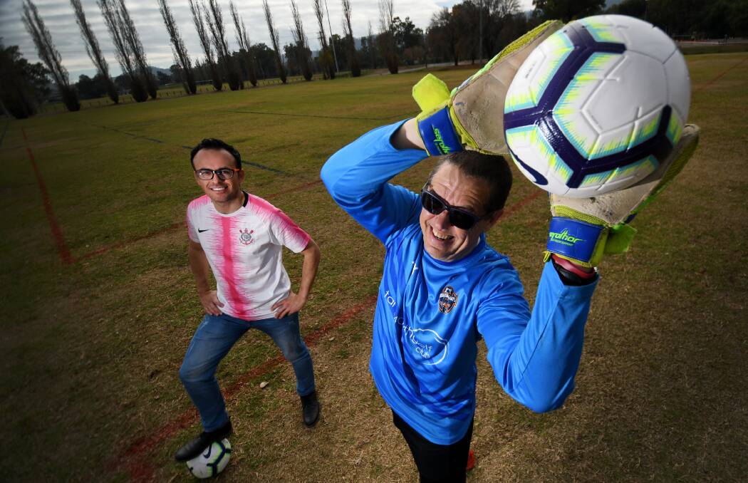 GOALS: Amigos United defender Ed Acosta and Tamworth Regional Council planning director Brent McAlister, who helped create the new multicultural football comp. Photo: Gareth Gardner 180619GGA03