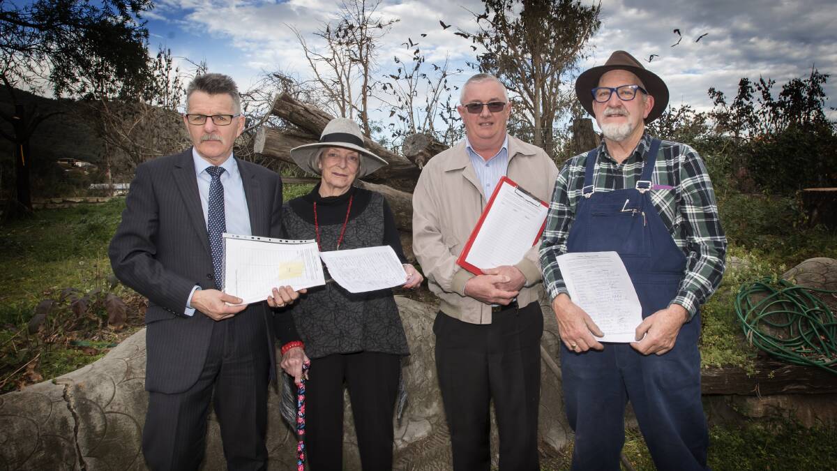 IN TO BAT: Craig Cox, Ruth Stuart, Jim Booth and Greg Clark circled a petition calling for the flying fox to be remeoved from the threatened species list. Photo Peter Hardin