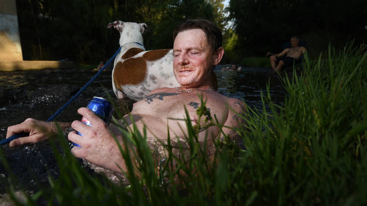 COOL SPOT: Danny Gardner and his pooch Chyna chilling out in the Peel River. Photo: Gareth Gardner 260119GGC01
