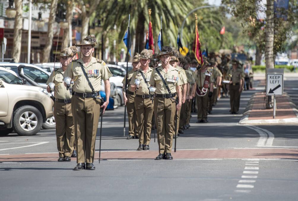 HONOUR: The Hunter River Lancers marched down the main street with swords drawn, a rare happening to mark the centenary of WWI's armistice. Photo: Peter Hardin 101118PHB024