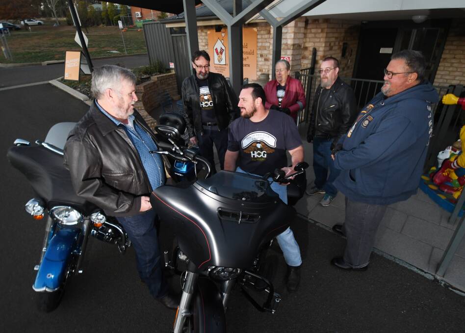 HORSE-POWERED HELPERS: House manager Steve Martin (left) chats to HOG director Gavin Westbrook (seated middle) and a number of local Harley owners at Ronald McDonald House. Photo: Gareth Gardner 300519GGF02