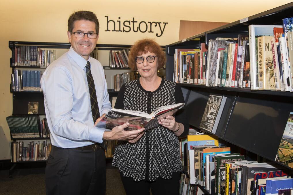 BALANCE THE BOOKS: Tamworth MP Kevin Anderson with library manger Kay Delahunt. Photo: Peter Hardin 300418PHB030