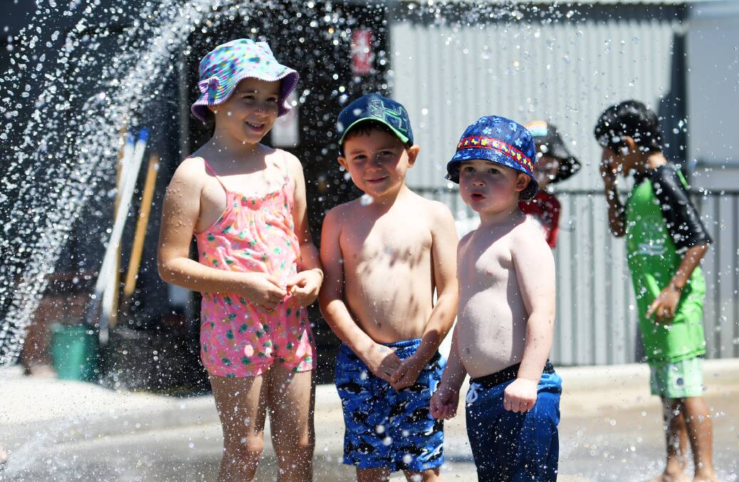 BEATING THE HEAT: Stella Bridges, 6, Leo, 4, and Jackson Bridges, 2, cooling off at the splash park on Kable Avenue. Photo: Gareth Gardner 291218GGA16.  