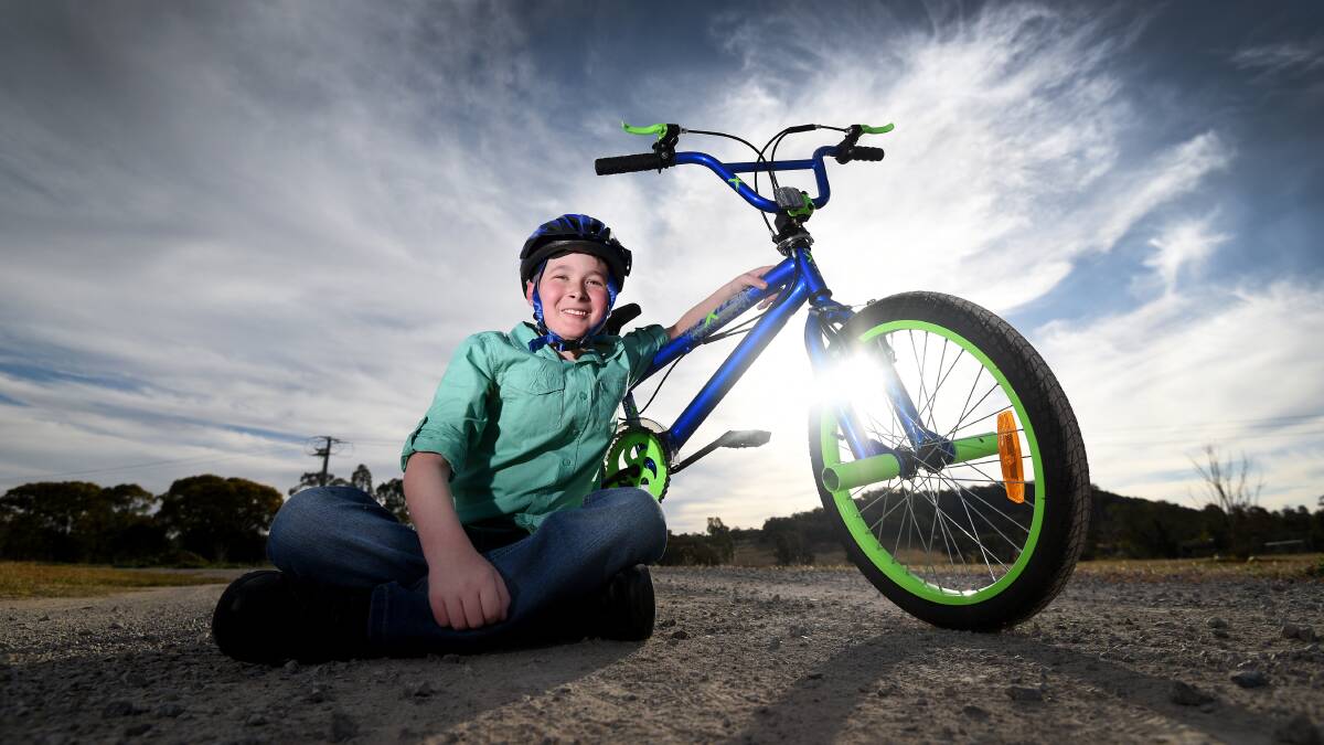 STILL SMILING: Alex Southwell, 11, with his new prized possession donated by the Ride for Sick Kids. Photo: Gareth Gardner 120917GGD10