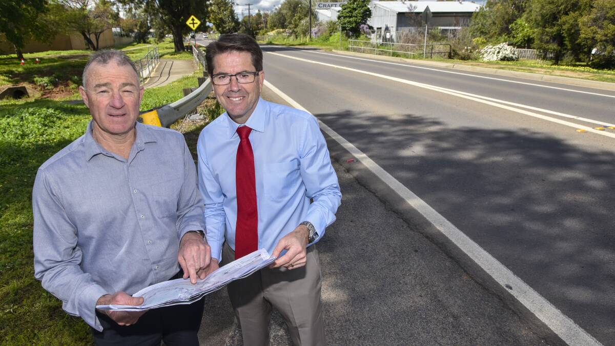 WAY TO GO: TRC regional services director Peter Resch and Tamworth MP Kevin Anderson look over the plans to widen a stretch of Manilla Rd. Photo: Peter Hardin 260916PHA019