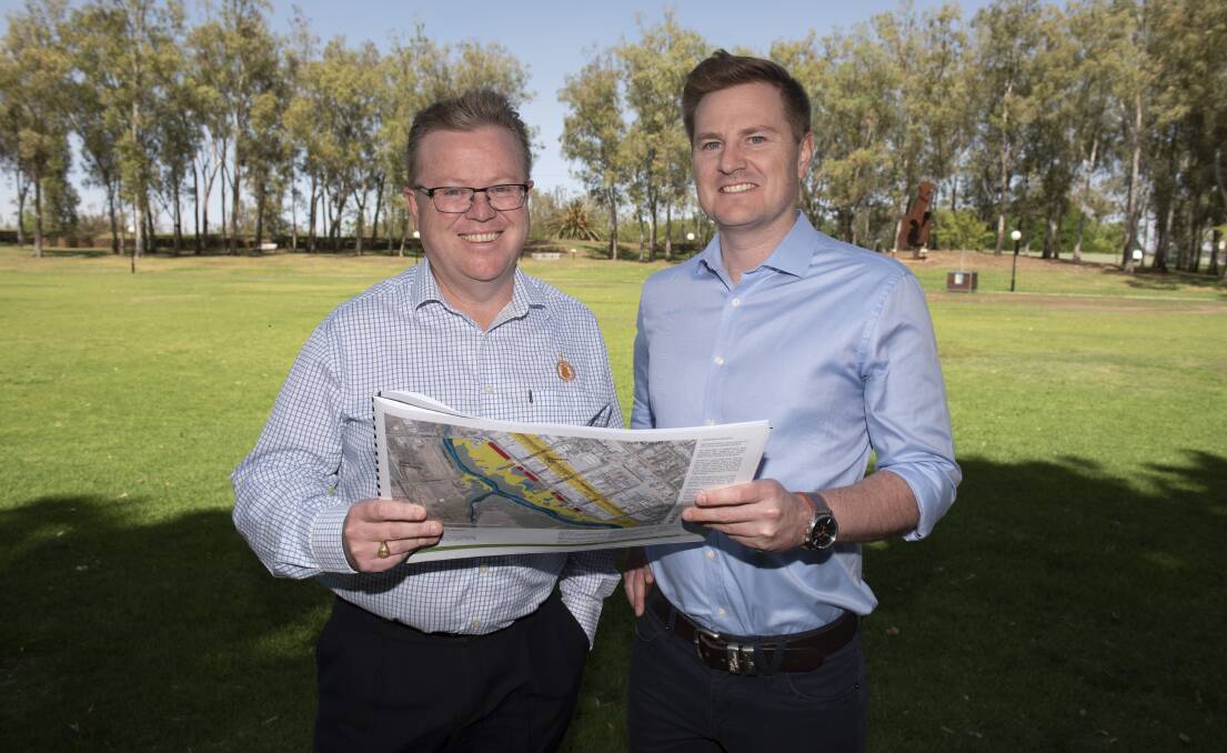 POOL PLANS: Tamworth council general manager Paul Bennett with sports and rec officer Sam Eriksson with the Bicentennial Park draft masterplan which will have an effect on the aquatic centre. Photo: Peter Hardin 071119PHB020