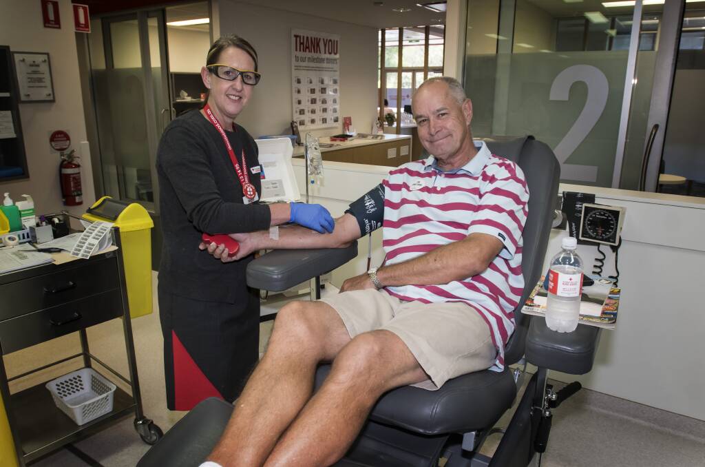 TAKING STOCK: Megan Dewhurst prepares Brad Hansen for his donation at the Tamworth blood bank. Photo: Peter Hardin 071218PHA010