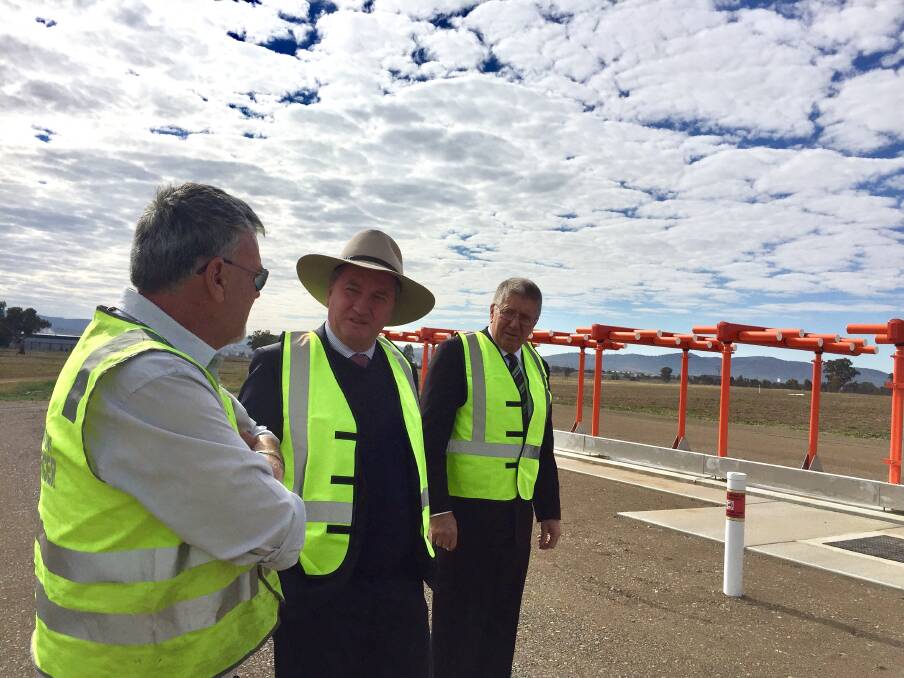 BE SEEN: New England MP Barnaby Joyce and Tamworth mayor Col Murray with airport staff inspecting the new ILS system. Photo: Jacob McArthur