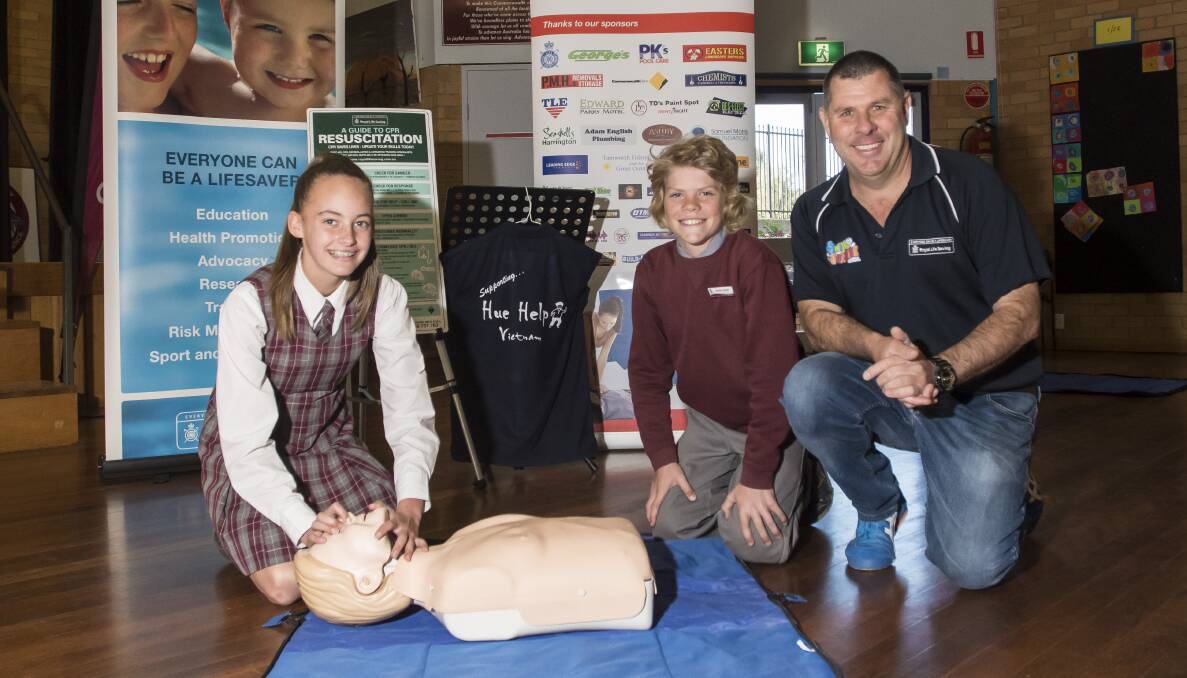 A NEW CLASS: Oxley Vale Public School students Imogen Smith and Colby Edgor with CPR teacher Cameron McFarlane whose resuscitation lessons will soon be launched overseas. Photo: Peter Hardin 210618PHB006