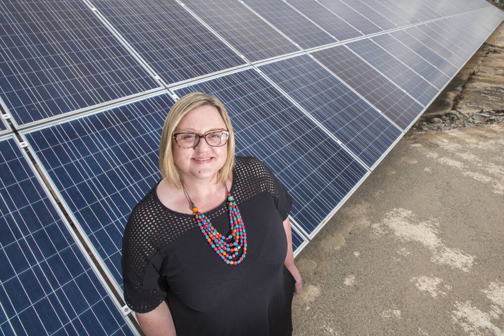 FROM THE SKY: Council's sustainability coordinator Tracey Carr at the Swan St pumping station solar array. Photo: Peter Hardin 201216PHF026
