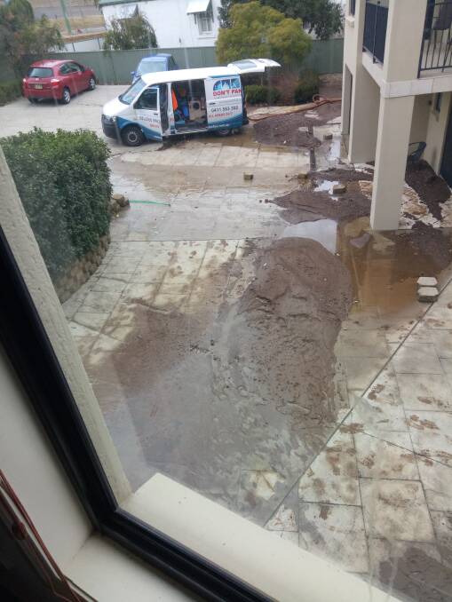 MUDDY WATERS: An amount of mud was pushed down the driveway and into homes after a water main burst on Armidale Road on Monday. Photo: Supplied