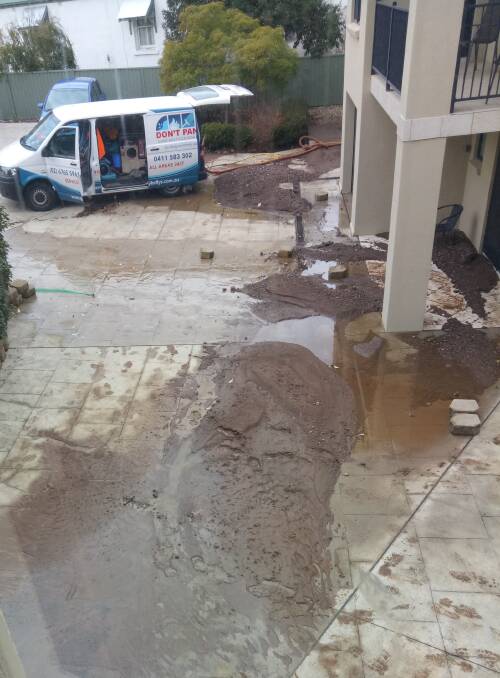 MUDDY WATERS: An amount of mud was pushed down the driveway and into homes after a water main burst on Armidale Road on July 2. Photo: Supplied