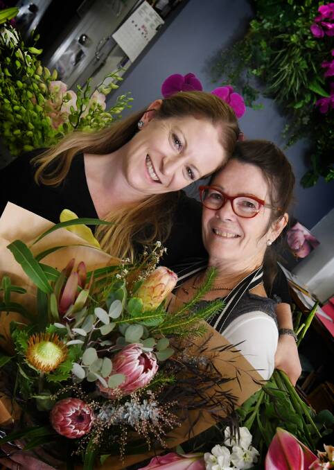 FLORAL THANKS: Many mums will be receiving bouquets from this family-duo on Mother's Day. Photo: Gareth Gardner 090518GGA001