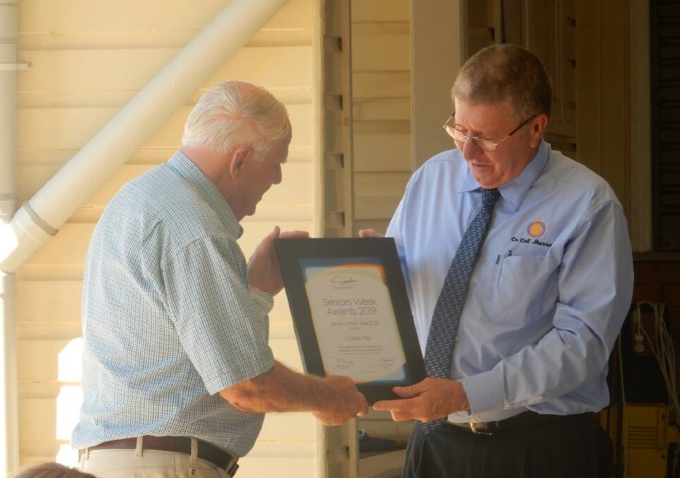 GIVING BACK: Nundle's senior citizen of the year Charles May receives his award from mayor Col Murray, kicking off NSW Seniors Festival activities. Photo: Supplied