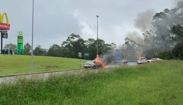 POLICE PURSUIT: The vehicle on fire at the Port Macquarie highway intersection on December 31. Photo: Mid North Coast Police