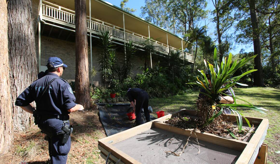 Police searching through the garden at William's foster grandmothers home where he went missing in 2014. Photo: NSW Police