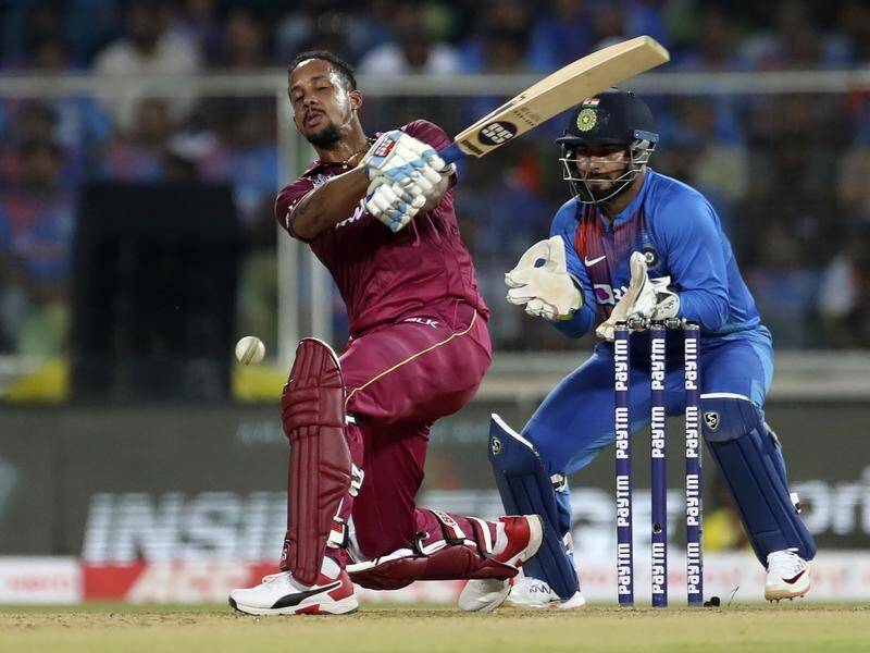 Lendl Simmons (L) in T20 action for West Indies against India in December.