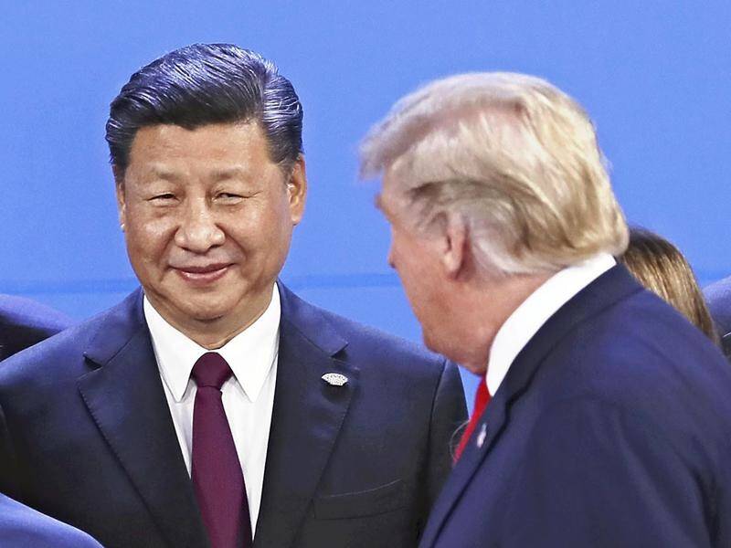 US President Donald Trump (R) says China's Xi Jinping has agreed to lower tariffs on American cars.