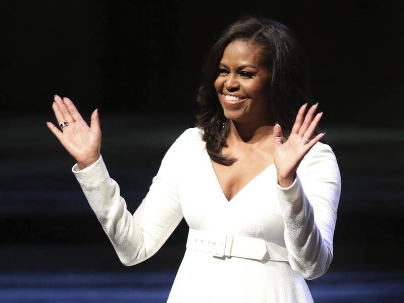 Michelle Obama has revisited the London school that inspired her global education drive.