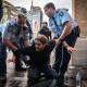 NSW Police officers hold a protester during the Blockade Australia rally in Sydney.