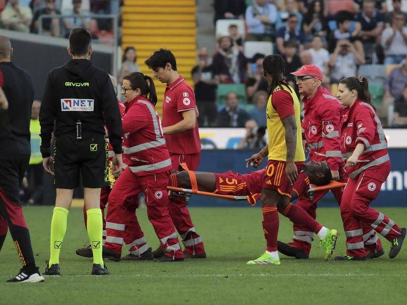 Roma's Evan Ndicka is carried off on a stretcher during the Serie A match at Udinese. (AP PHOTO)