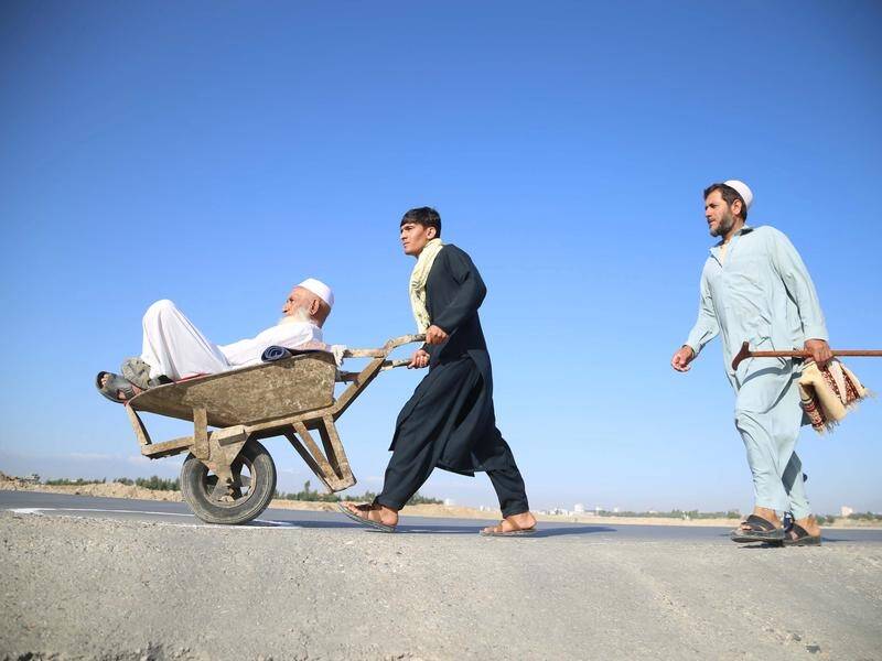 Men arrive for Eidl al-Fitr prayers to mark the end of Ramadan, in Jalalabad, Afghanistan.