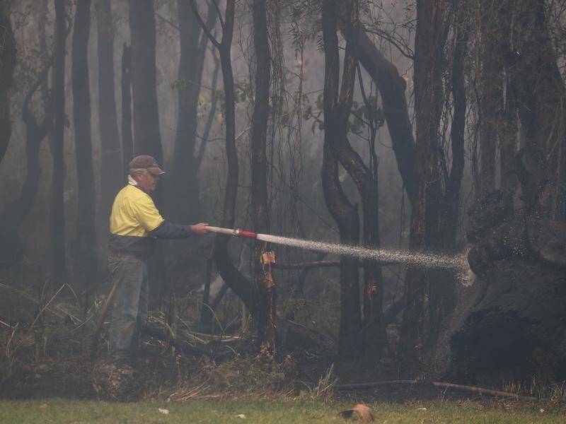 Blazes in northern NSW have been downgraded but temperatures are forecast to pick up on the weekend.