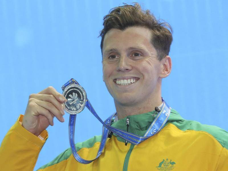 Thomas Fraser-Holmes shows off his 400m IM silver medal at the short-course world swimming titles.