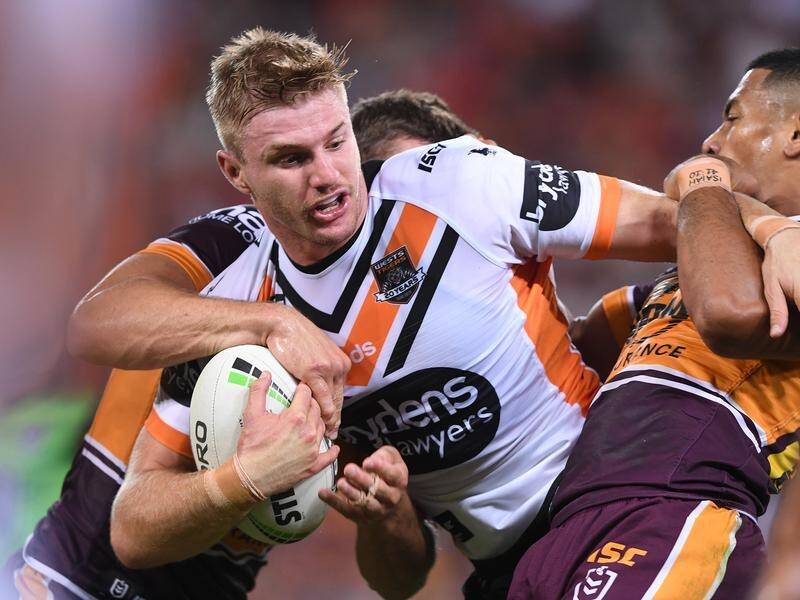 Luke Garner of the Tigers looks to offload during his side's NRL clash with Brisbane.