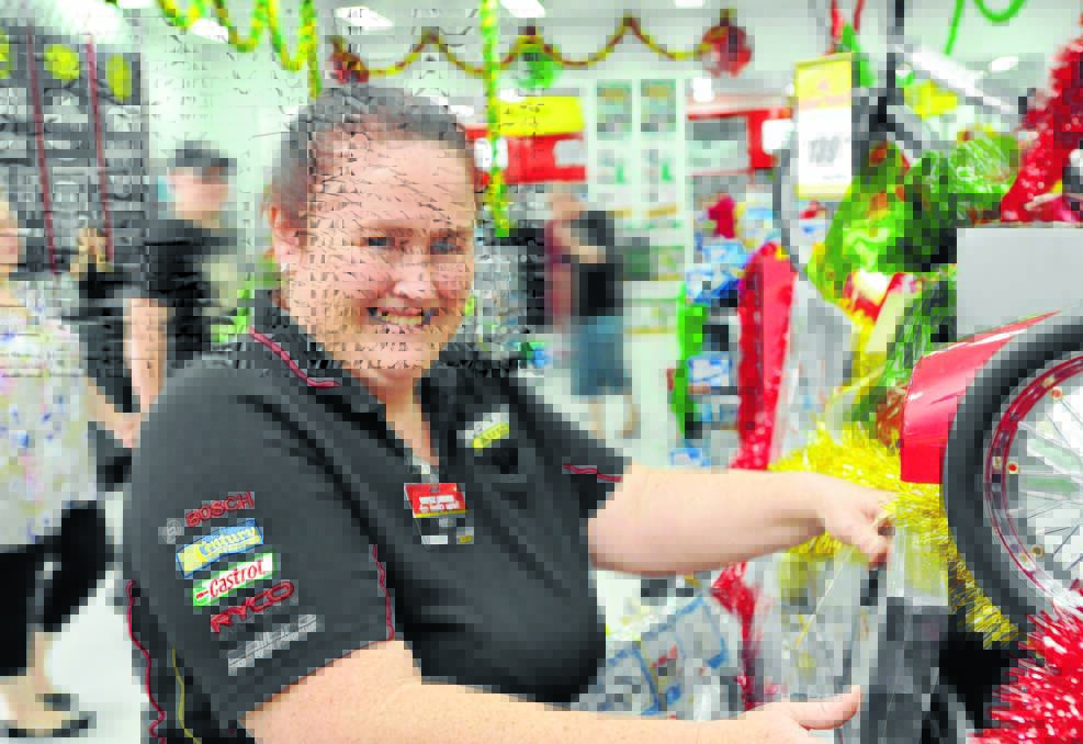 NO REST: in 2013, Tamworth's Supercheap Auto manager Danielle Baker was tracking down an item for one of the many customers making the most of the store's Boxing Day sale. Photo: Geoff O'Neill 261213GOA01