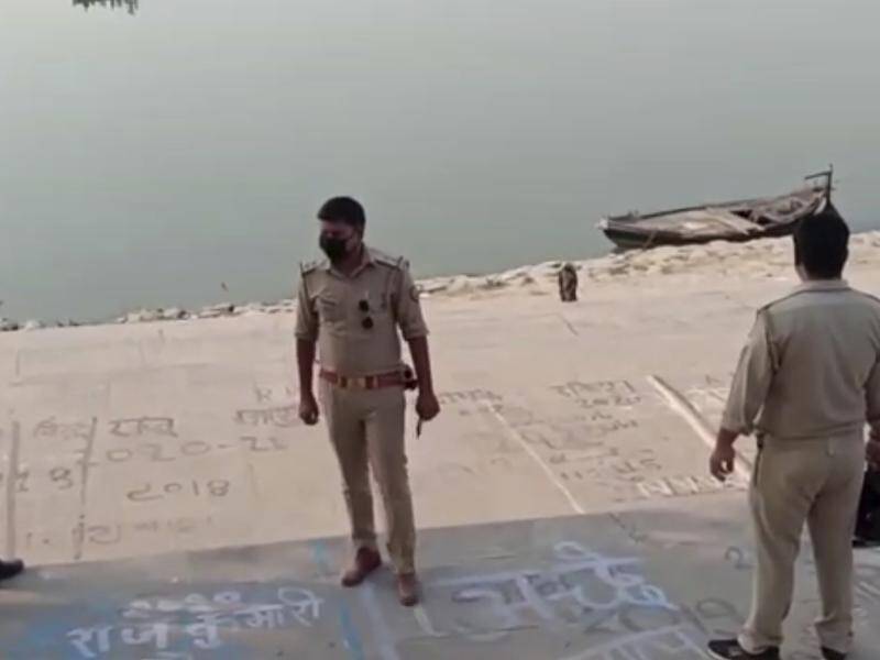 Police officers stand guard near where bodies were found floating in the Ganges river in India.