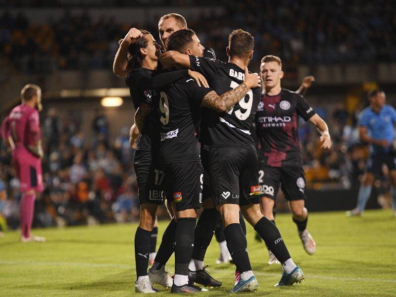 Melbourne City players celebrating after Jamie Maclaren's late penalty equaliser against Sydney FC.