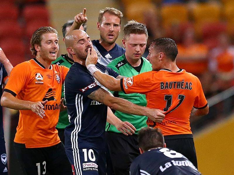 Brisbane's Eric Bautheac (R) has been sent off in the Roar's 4-2 A-League loss to Melbourne Victory.
