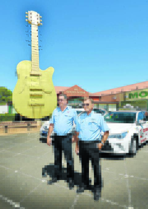 FARE GO: Tamworth cabbies Daryl Gay and Terry Mathison at the Big Golden Guitar. Photo: Barry Smith 080116BSA05